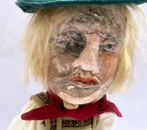 Sculpture: Otto head close Hacked doll with soft body and china hands and feet. Doll face is replaced with uncanny head made from textile.