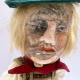 Sculpture: Otto head close Hacked doll with soft body and china hands and feet. Doll face is replaced with uncanny head made from textile.