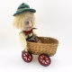 Sculpture: Otto in wicker cart Hacked doll with soft body and china hands and feet. Doll face is replaced with uncanny head made from textile.