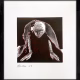 A woman crawls along the ground. She is bald, skeletal and covered in a removal blanket. Printed and tinted/shaded in black and red.