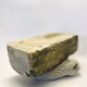 Soft sculpture head crushed by a brick