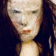 Uncanny girl doll with long dark brown hair. Face detail.