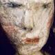 Uncanny girl doll with long dark brown hair. Face detail.