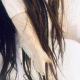 Uncanny girl doll with long dark brown hair. Detail view with hand, leg and hair.