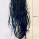 Uncanny girl doll with long dark brown hair. Back view.