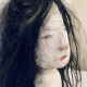 Uncanny girl doll with long dark brown hair. Face profile view.