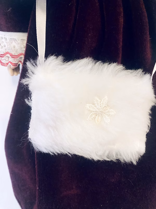 Doll detail: fluffy, furry white handbag.