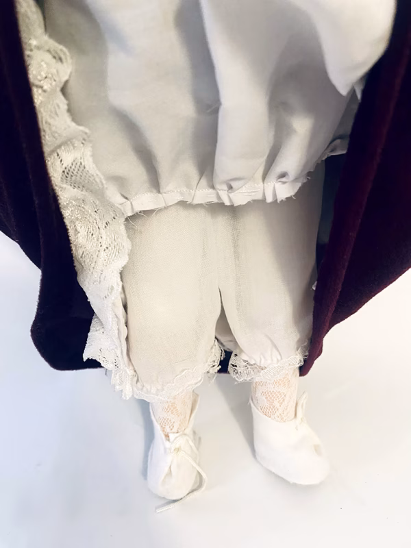 Doll detail: white lacy tights and long knickers.