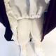 Doll detail: white lacy tights and long knickers.