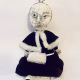 Hacked doll with a Kilner jar clip around its 'ugly' uncanny head.