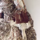 Doll with decayed silk dress.