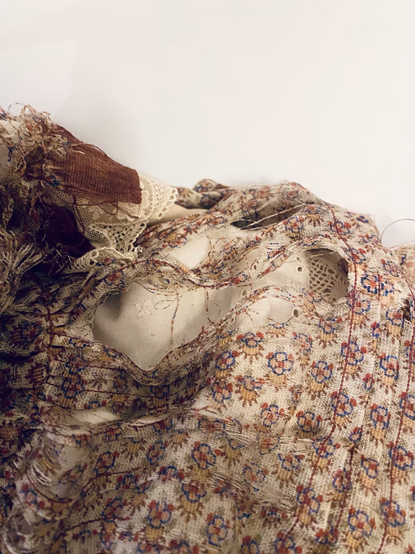 Doll with decayed silk dress.