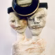 Double headed skeletal torso sculpture crowned with a vintage mechanical hubodometer