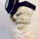 Double headed skeletal torso sculpture crowned with a vintage mechanical hubodometer