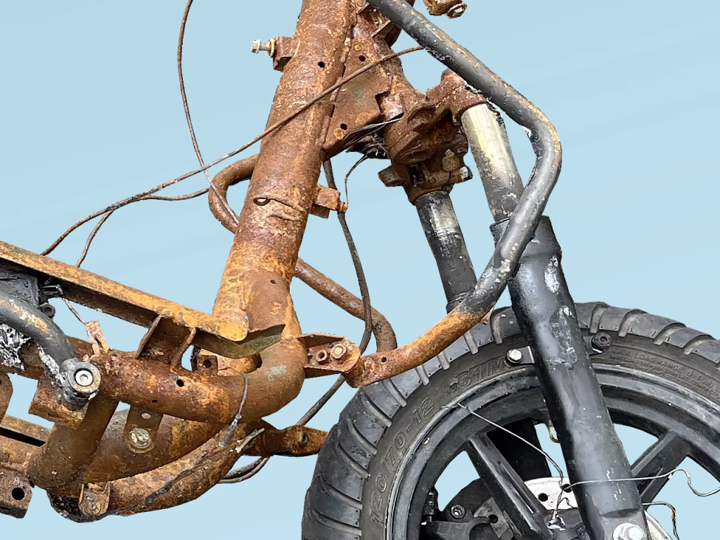 Partial image of a torched motorbike on blue background