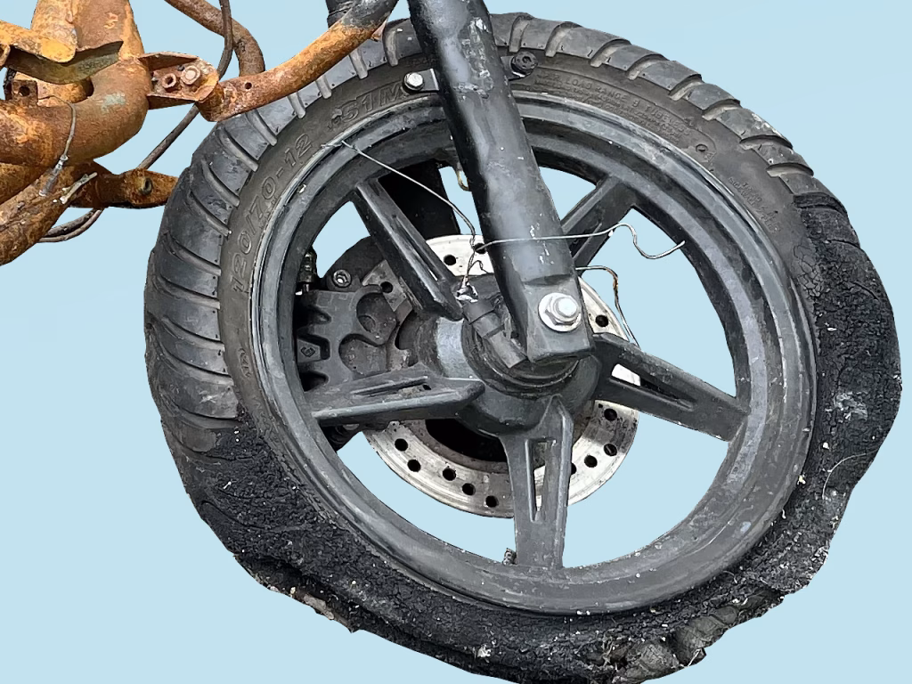 Partial image of a torched motorbike on blue background