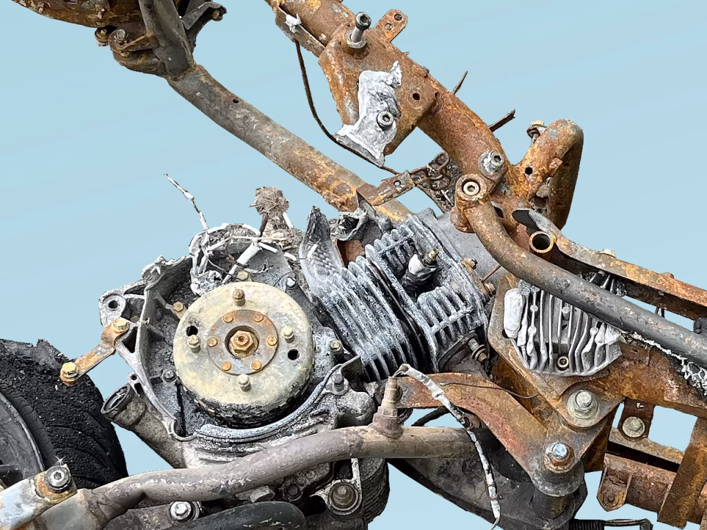 Partial image of a torched motorbike on blue background
