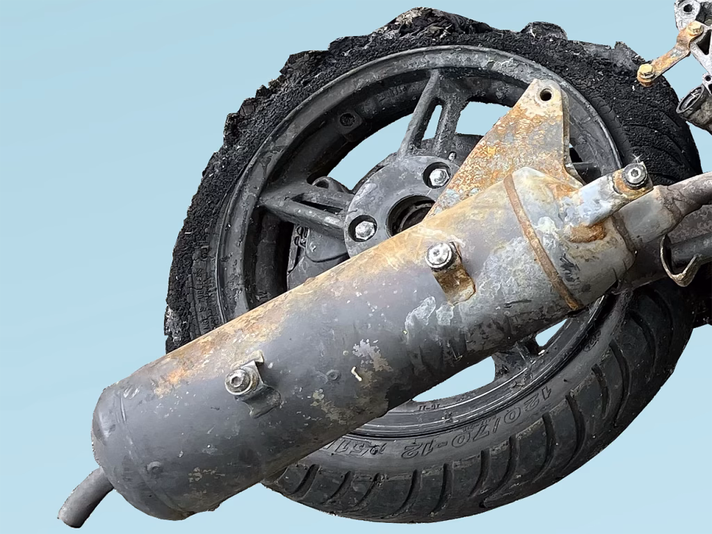 Partial image of a torched motorbike on blue background