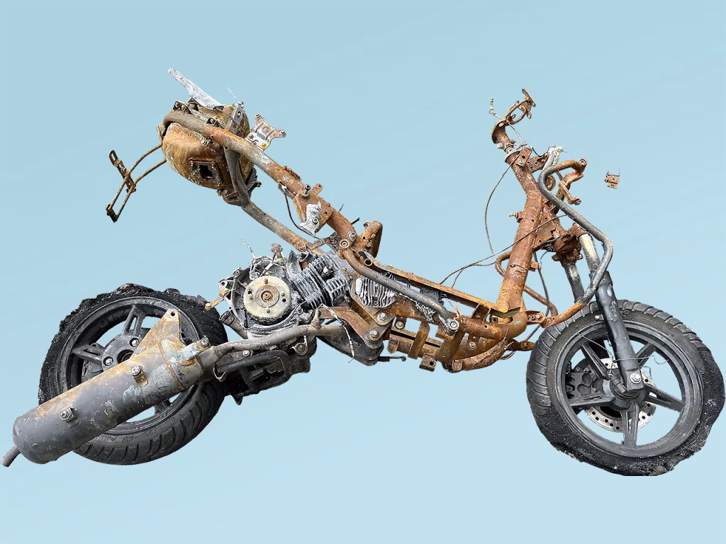 Image of a torched motorbike on blue background