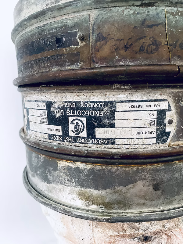 Three stacked laboratory sieves.