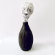 Small sculpture head emerging from ceramic pot
