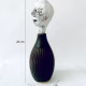Small sculpture head emerging from ceramic pot