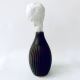 Small sculpture head emerging from ceramic pot