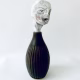 Small sculpture head emerging from ceramic pot
