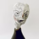 Small sculpture head emerging from ceramic pot