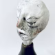 Small sculpture head emerging from ceramic pot