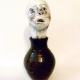 Small sculpture head emerging from ceramic pot