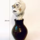 Small sculpture head emerging from ceramic pot