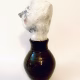 Small sculpture head emerging from ceramic pot
