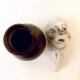 Small sculpture head next to ceramic pot