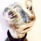 Small sculpture head emerging from ceramic pot