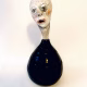 Small sculpture head emerging from ceramic pot