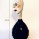 Small sculpture head emerging from ceramic pot