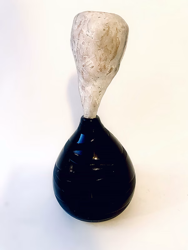 Small sculpture head emerging from ceramic pot