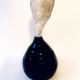 Small sculpture head emerging from ceramic pot