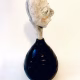 Small sculpture head emerging from ceramic pot