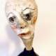 Small sculpture head emerging from ceramic pot