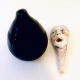 Small sculpture head next to ceramic pot